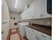 Functional laundry room equipped with modern washer and dryer, ample cabinet space, and countertop at 4687 Nw 35Th Lane Rd, Ocala, FL 34482