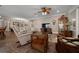 Comfortable living room boasts wood floors, ceiling fan, and plenty of seating at 4687 Nw 35Th Lane Rd, Ocala, FL 34482