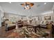 Spacious living room flows into kitchen and dining areas with wood floors and ceiling fan at 4687 Nw 35Th Lane Rd, Ocala, FL 34482