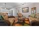 Sitting room adjacent to kitchen features open-concept design, wicker furniture, and colorful rug at 4687 Nw 35Th Lane Rd, Ocala, FL 34482