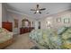 This main bedroom features neutral walls, carpet, a ceiling fan, and a beautiful ensuite bathroom at 4687 Nw 35Th Lane Rd, Ocala, FL 34482