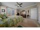 This main bedroom features neutral walls, carpet, a ceiling fan, and a large window at 4687 Nw 35Th Lane Rd, Ocala, FL 34482