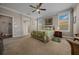 Bright main bedroom featuring neutral walls, carpet, ceiling fan, and a lovely ensuite bathroom at 4687 Nw 35Th Lane Rd, Ocala, FL 34482