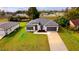 New home with a well-manicured lawn and a long concrete driveway at 492 Marion Oaks Mnr, Ocala, FL 34473