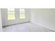 Bright bedroom with gray wood-look flooring and two windows providing natural light at 492 Marion Oaks Mnr, Ocala, FL 34473