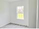 Minimalist bedroom with wood-look floors and a window overlooking the yard at 492 Marion Oaks Mnr, Ocala, FL 34473