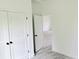 Neutral room featuring a closet, gray wood-look floors, and white walls at 492 Marion Oaks Mnr, Ocala, FL 34473