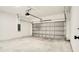 Spacious two car garage with white brick walls and concrete floor at 492 Marion Oaks Mnr, Ocala, FL 34473