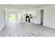 Open concept kitchen with white cabinets, stainless steel appliances, and large island with modern pendant lighting at 492 Marion Oaks Mnr, Ocala, FL 34473