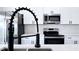 Close up of kitchen island, faucet, stainless appliances and modern cabinetry at 492 Marion Oaks Mnr, Ocala, FL 34473