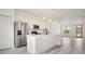 Bright kitchen with white cabinets, stainless steel appliances, and center island with breakfast bar at 492 Marion Oaks Mnr, Ocala, FL 34473