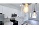 Bright kitchen featuring white cabinetry, modern appliances, and stylish pendant lighting above the island at 492 Marion Oaks Mnr, Ocala, FL 34473
