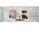 Kitchen featuring modern stainless steel appliances, white cabinetry, and an island with sink at 492 Marion Oaks Mnr, Ocala, FL 34473
