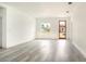 Spacious living room featuring light gray floors, white walls, a modern wood door, and a bright, open space at 492 Marion Oaks Mnr, Ocala, FL 34473