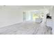 Open-concept living space featuring a kitchen with an island and light gray flooring throughout the home at 492 Marion Oaks Mnr, Ocala, FL 34473