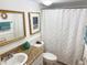 Well-lit bathroom with a framed mirror and patterned shower curtain at 510 Cranes Way # 206, Altamonte Springs, FL 32701