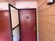 Close-up of unit 206's red front door with security screen at 510 Cranes Way # 206, Altamonte Springs, FL 32701