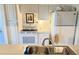 Compact kitchen featuring white appliances and cabinetry at 510 Cranes Way # 206, Altamonte Springs, FL 32701