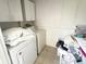 Well-lit laundry area features a washer, dryer, and storage cabinets at 510 Cranes Way # 206, Altamonte Springs, FL 32701