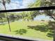 Serene water view from the lanai, framed by lush greenery and mature trees at 510 Cranes Way # 206, Altamonte Springs, FL 32701