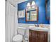 Bathroom with blue walls, modern vanity, and a toilet at 512 Derby Dr, Altamonte Springs, FL 32714