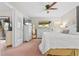 Bright bedroom showcasing a large window, ceiling fan, an ensuite and a light, neutral color palette at 512 Derby Dr, Altamonte Springs, FL 32714