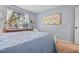 Comfortable bedroom with light blue walls, a double bed, and natural light from the window at 512 Derby Dr, Altamonte Springs, FL 32714