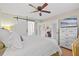 This bedroom features a modern ceiling fan, a barn door, and a view into the living room at 512 Derby Dr, Altamonte Springs, FL 32714