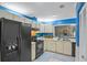 Bright kitchen with blue accent paint, white cabinetry, black appliances, and tile floor at 512 Derby Dr, Altamonte Springs, FL 32714