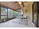 This covered and screened patio features a tiled floor, furniture and a view of the fenced yard at 512 Derby Dr, Altamonte Springs, FL 32714