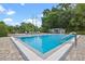 This community pool is surrounded by a brick paver deck with lounge chairs, and a covered eating area at 512 Derby Dr, Altamonte Springs, FL 32714