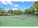 Scenic view of community tennis courts surrounded by trees and lighting for evening play at 512 Derby Dr, Altamonte Springs, FL 32714