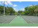 Enjoy a match on well-maintained tennis courts with lush greenery and clear skies enhancing the outdoor experience at 512 Derby Dr, Altamonte Springs, FL 32714