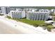 Aerial view of beachfront condo buildings with ocean access and manicured lawn at 5203 S Atlantic Ave # 416B, New Smyrna Beach, FL 32169