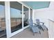 Balcony with lounge chairs overlooking the ocean and coastal scenery from sliding glass doors at 5203 S Atlantic Ave # 416B, New Smyrna Beach, FL 32169