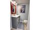 Well-appointed bathroom featuring a vanity with storage and charming nautical artwork at 5203 S Atlantic Ave # 416B, New Smyrna Beach, FL 32169