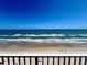 Gorgeous ocean views from this balcony overlooking a sandy beach, waves and sunbathers at 5203 S Atlantic Ave # 416B, New Smyrna Beach, FL 32169