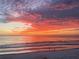 Striking sunrise paints the beach and ocean in vibrant hues, creating a picturesque scene at 5203 S Atlantic Ave # 416B, New Smyrna Beach, FL 32169