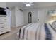 Relaxing bedroom with a ceiling fan, TV, closet, and comfortable striped bedding at 5203 S Atlantic Ave # 416B, New Smyrna Beach, FL 32169