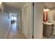 Hallway view to the bathroom and living room with multiple closets for storage at 5203 S Atlantic Ave # 416B, New Smyrna Beach, FL 32169