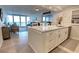 Bright kitchen featuring white cabinetry, stone countertops and stainless steel appliances at 5203 S Atlantic Ave # 416B, New Smyrna Beach, FL 32169