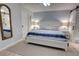 Serene main bedroom with coastal-inspired decor, featuring a comfortable bed and soft lighting at 5203 S Atlantic Ave # 416B, New Smyrna Beach, FL 32169