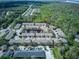 Aerial view of a townhome community with a pond, mature trees, and well-maintained landscaping at 558 Pinebranch Cir, Winter Springs, FL 32708