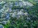 Wide aerial shot showcasing the home's location in a leafy area surrounded by other residential properties at 558 Pinebranch Cir, Winter Springs, FL 32708