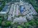 Aerial view of a serene townhome community with a central pond and lush landscaping at 558 Pinebranch Cir, Winter Springs, FL 32708