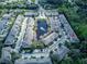 Aerial view of a townhome community encircling a tranquil pond with a fountain feature at 558 Pinebranch Cir, Winter Springs, FL 32708