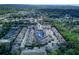 Drone shot showcases a lush residential area with townhomes centered around a peaceful pond at 558 Pinebranch Cir, Winter Springs, FL 32708