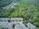 Aerial view of townhouses nestled among lush greenery, showcasing community layout and serene surroundings at 558 Pinebranch Cir, Winter Springs, FL 32708