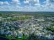 Expansive aerial view of a residential neighborhood with mature trees and various home styles, showing community layout at 558 Pinebranch Cir, Winter Springs, FL 32708