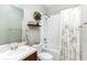 Cozy bathroom featuring a single sink vanity and a shower with a plant shelf for decor at 558 Pinebranch Cir, Winter Springs, FL 32708